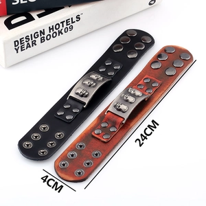 Punk style wide leather bracelets with skull charms and studs in black and reddish brown