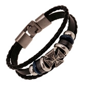 Detailed macro view of multi-layer braided leather bracelet with iron cross charm