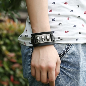 Men punk wide black leather bracelet featuring three silver metal 3D skull charms