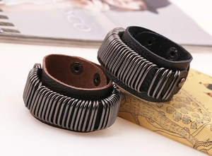 Detail of punk leather bracelet with metal rings and snap buttons in industrial style