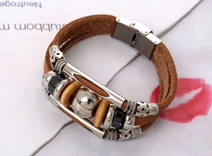 Close-up of multilayer leather bracelet with silver tubes and engraved metal beads