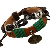 Detail of multi-layer leather braided bracelet with green thread and vintage metal charms