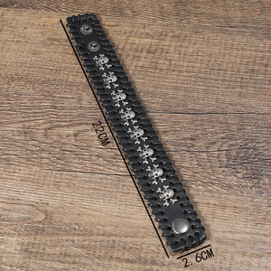 Retro punk black leather bracelet for men featuring metallic skull studs and woven edges