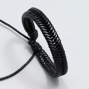 Macro detail of the spiral woven black leather strap with adjustable knot closure