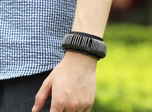 Detail of punk style wide black leather bracelet with silver metal rings on male wrist