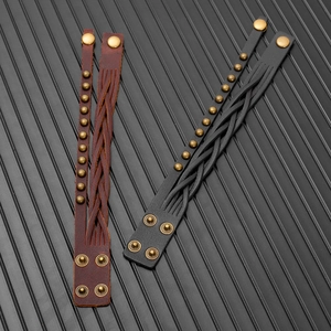 Detail of vintage multilayer braided leather bracelets with brass rivets and snap buttons