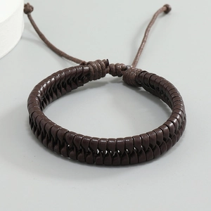 Close-up of a dark brown braided leather bracelet with adjustable sliding knot closure