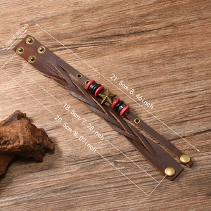 Vintage braided leather bracelet with star charm and beads on a rustic wood background