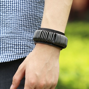 Punk style wide leather bracelet with multiple silver metal rings and textured finish