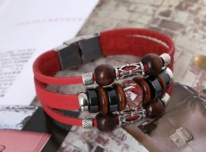 Macro shot of red layered leather bracelet with vintage beads and magnetic metal clasp