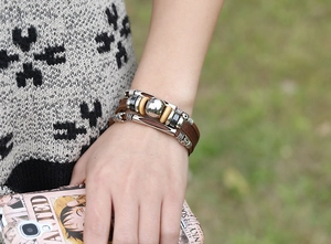 Close-up of multilayer leather bracelet featuring silver metal beads and retro vintage style