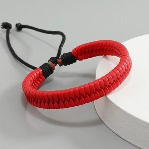 Close-up of red braided leather bracelet with adjustable black drawstring knot