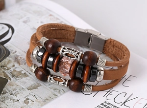 Macro detail of braided leather bracelet with vintage beads and magnetic steel clasp