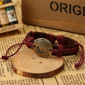 Macro view of vintage Pisces zodiac leather bracelet with embossed bronze emblem