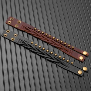 Detail of woven leather bracelets with bronze rivets and adjustable metal snap buttons