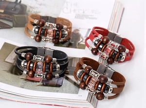 Detail of bohemian braided leather bracelets with wooden beads and crystal accents