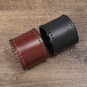 Two-piece punk leather wristbands in black and brown with cross-stitch and metal buttons