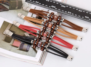 Detail of retro braided leather multi-layer bracelets with beads and metal buckle