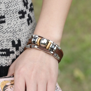 Retro multi-layer leather bracelet featuring silver beads and wood accents on a model