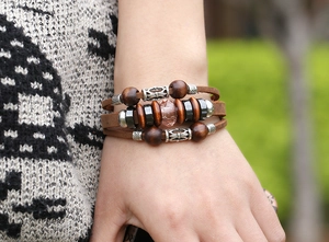 Detail of vintage braided leather bracelet with multi-layer beads and pink crystal stone