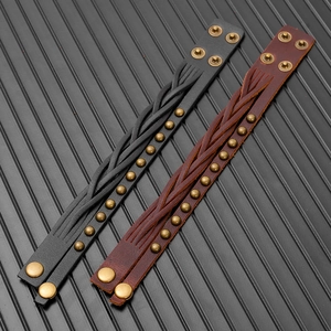 Close-up of vintage multi-layer braided leather bracelets with brass rivet studs