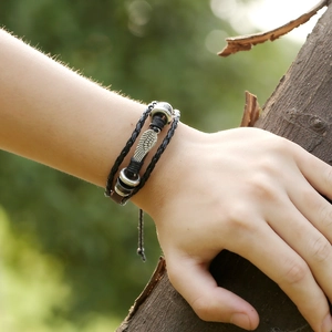 Punk style multi-layer black leather bracelet with silver wing charm and beaded accents
