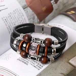 Vintage layered woven leather bracelet with wooden beads and pink crystal charm