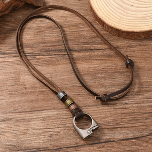 Close-up of retro adjustable leather necklace with vintage metal beads on wooden background