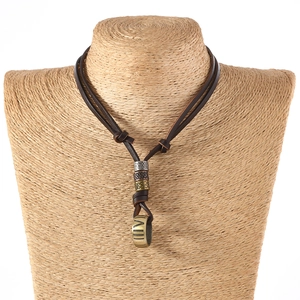 Detail of vintage leather necklace featuring antique gold metal beads and Roman numerals