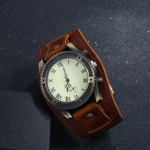 Close-up of vintage punk quartz watch with dark brown cowhide leather strap and bronze rivets