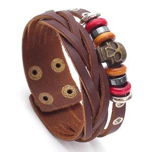 Vintage braided leather bracelet for men featuring a metal skull and multi-layer beads