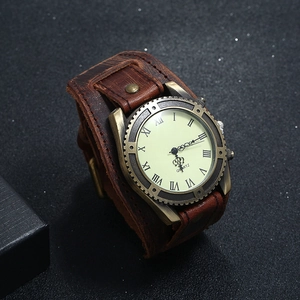 Detailed side view of vintage men's quartz watch with wide brown leather cuff and bronze case