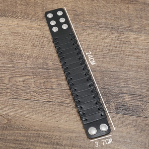 Detail of a 24cm black braided leather punk bracelet with silver metal snap buttons