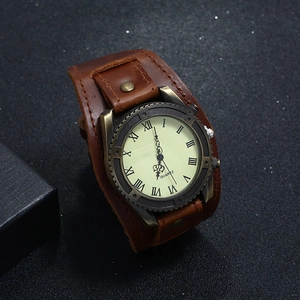 Macro view of vintage brown leather strap and roman numeral dial on bronze quartz watch