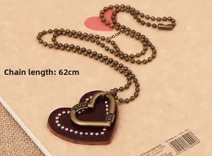Detail of vintage heart leather pendant with 62cm bronze chain and engraved accents