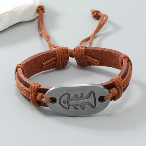 Detailed close-up of handmade vintage leather bracelet with metal fishbone engraving