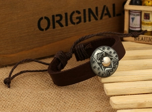 Detail of dark brown leather bracelet with vintage star engraved metal buckle charm