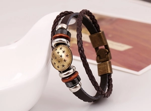 Detail of vintage multilayer leather bracelet with bronze star charm and magnetic clasp