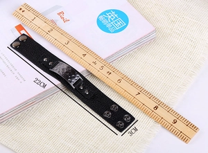 Close-up of black leather bracelet showing 22cm length and 3cm width dimensions