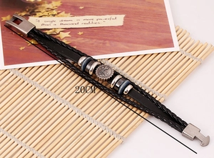 Detail of 20CM black braided leather bracelet with vintage silver gear beads on bamboo mat