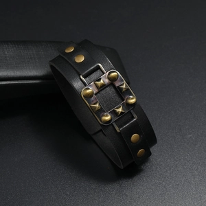Makroaufnahme eines Vintage Lederarmbands mit bronzefarbenen Nieten und Bolzen