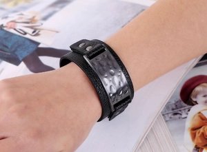 Close-up of black litchi pattern leather bracelet with hammered metal plate decoration