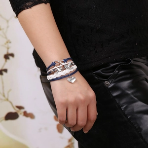 Bohemian braided bracelet with silver birds and heart pendant engraved with Sister