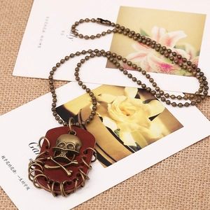 Vintage bronze skull pendant necklace with leather detail and long beaded chain links