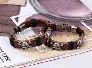 Detail of retro leather skull bracelet set with vintage silver metal hardware