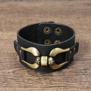 Detailed close-up of punk black leather wristband with bronze buckles and metal rivets