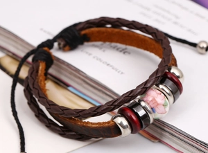 Detail of multilayer woven leather bracelet with ceramic bead and adjustable drawstring