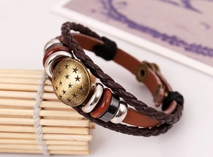 Macro shot of multi-layer leather bracelet with bronze star charms and wood beads