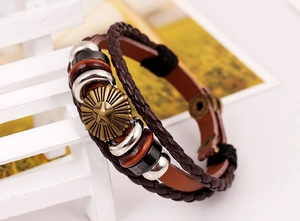 Detail view of multi-layer leather bracelet with star metal charm and wooden beads
