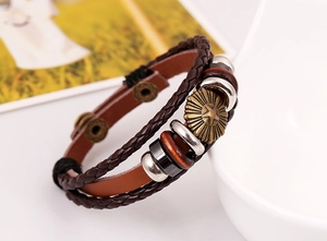 Detail view of retro multilayer brown leather bracelet with star bronze charm and beads